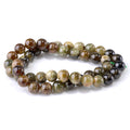 This is a Dakota Stones 8mm Green Garnet Banded Gemstone strand with round beads in 15-16 inch strand.