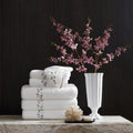 Matouk Jasmine Giza white long staple cotton luxury bath towels with elegant jasmine stem embroidery finished with a complementing tape edge