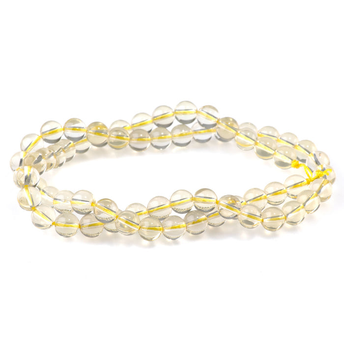 This is a Dakota Stones 6mm Lemon Quartz Gemstone strand with round beads in 15-16 inch strand.