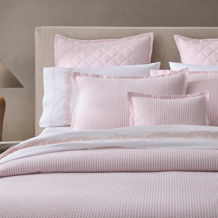 Matouk Matteo Cotton Seersucker Bedding in pink stripe with Atoll pillowcases and Matteo Quilted Euro Shams