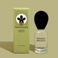 A glass bottle of Nopalera "Basque Mistico" perfume next to its green packaging box against a lighter green background.