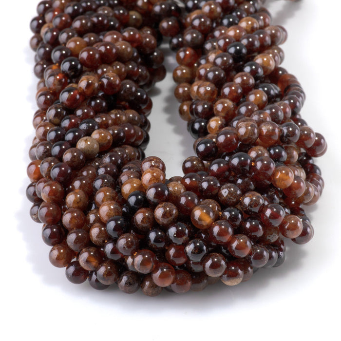 This is a Dakota Stones 6mm Orange Garnet Gemstone strand with round beads in 15-16 inch strand.