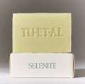 Bar of soap with 'TU•ET•AL' branding on a gray background